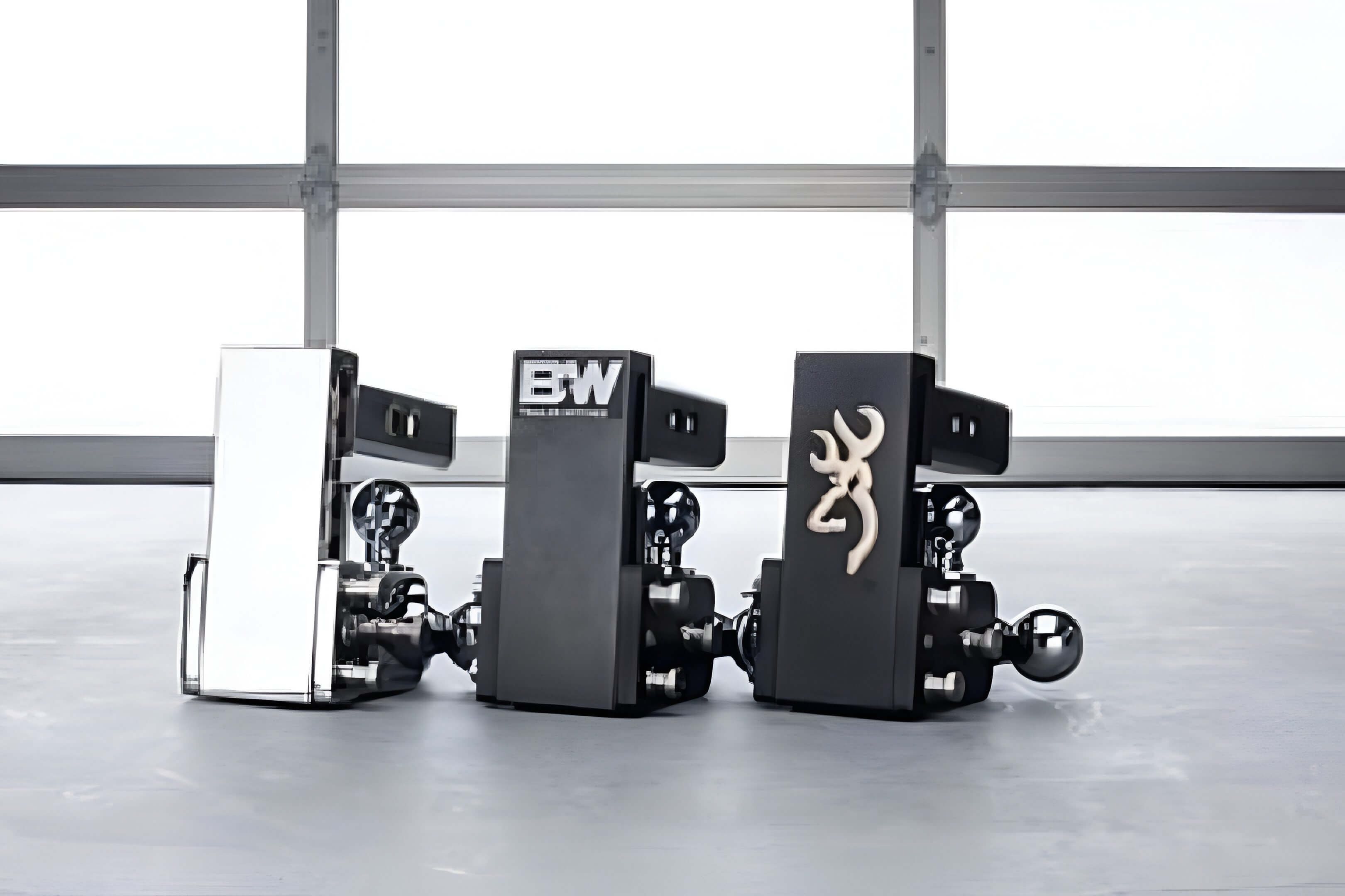 Three black lighters with distinct logos standing upright on a gray surface.